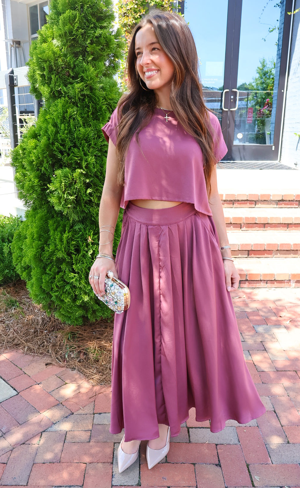 Mauve satin two-piece set with a boxy crop top and pleated midi skirt