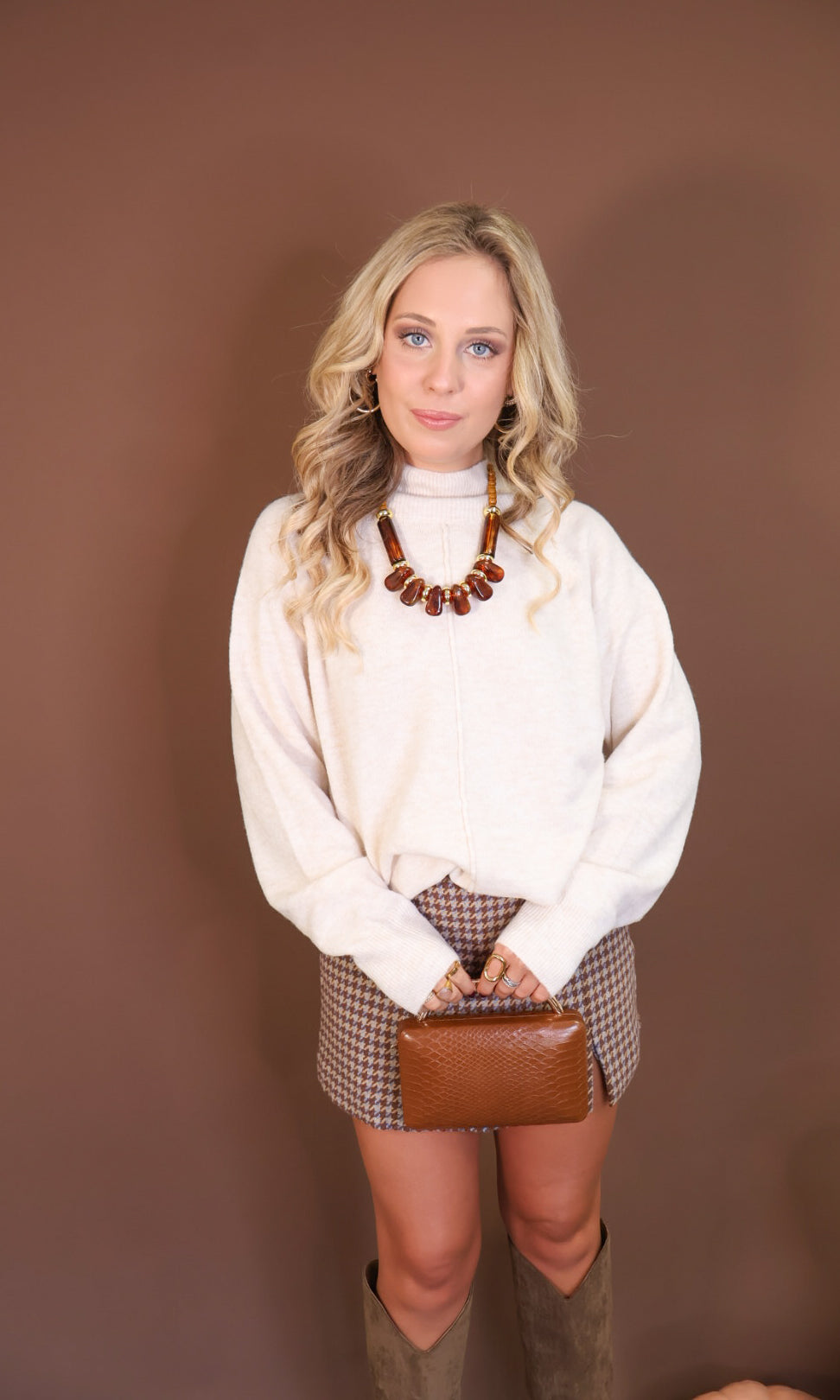 Oatmeal Mock Neck Tunic Sweater — front view styled with a handbag.
