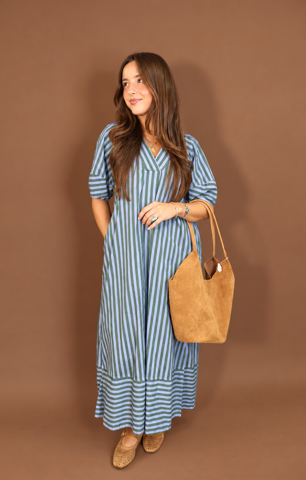 Model wearing the Blue Green Striped Midi Dress from Moda Boutique
