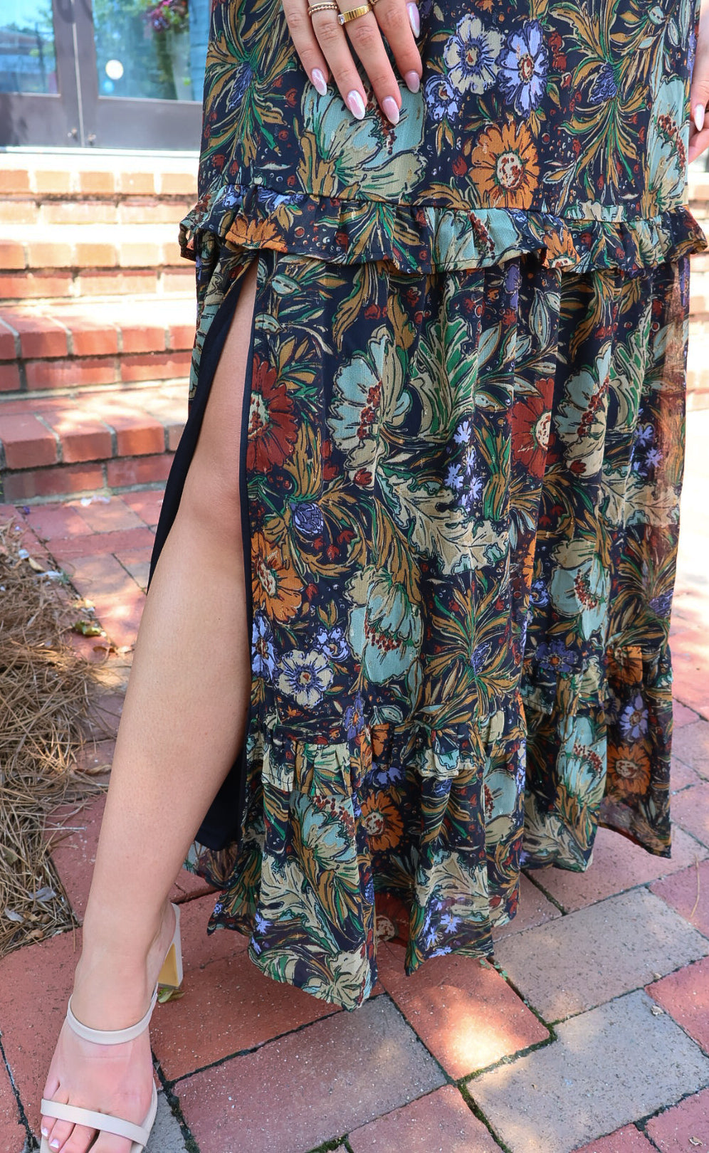 Bohemian floral maxi dress with a V-neck, flutter sleeves, and a tiered ruffle skirt