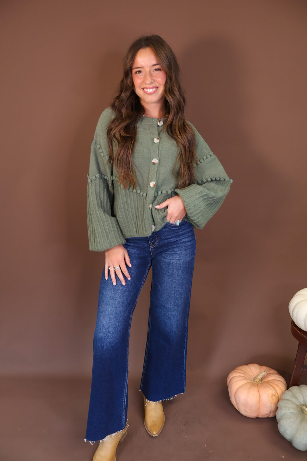 Olive Pom Pom Knit Cardigan — full outfit with blue jeans.