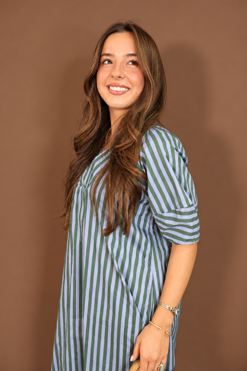 Model wearing the Blue Green Striped Midi Dress from Moda Boutique