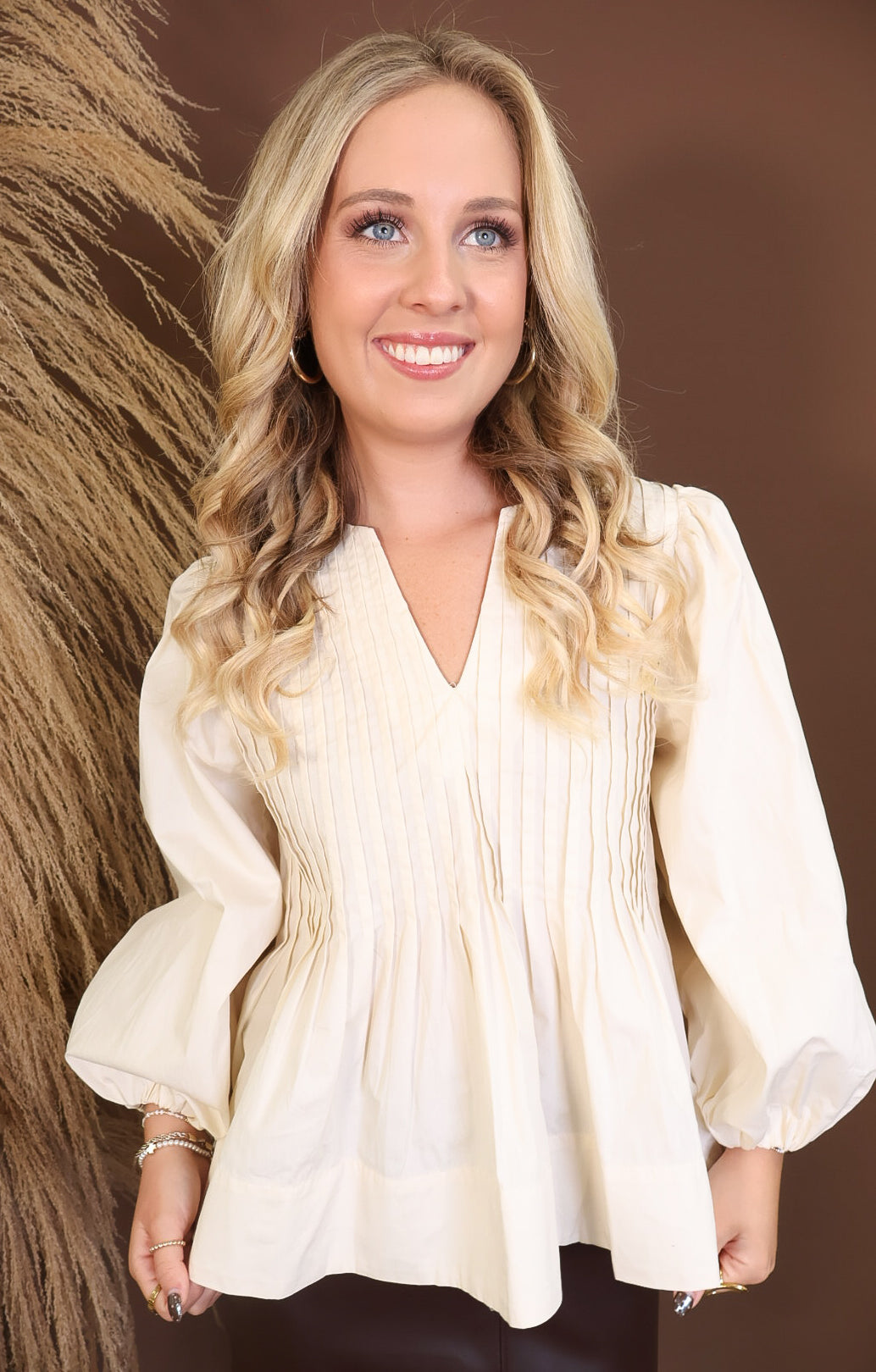 Model wearing the Cream Pintuck Quarter Sleeve Top from Moda Boutique