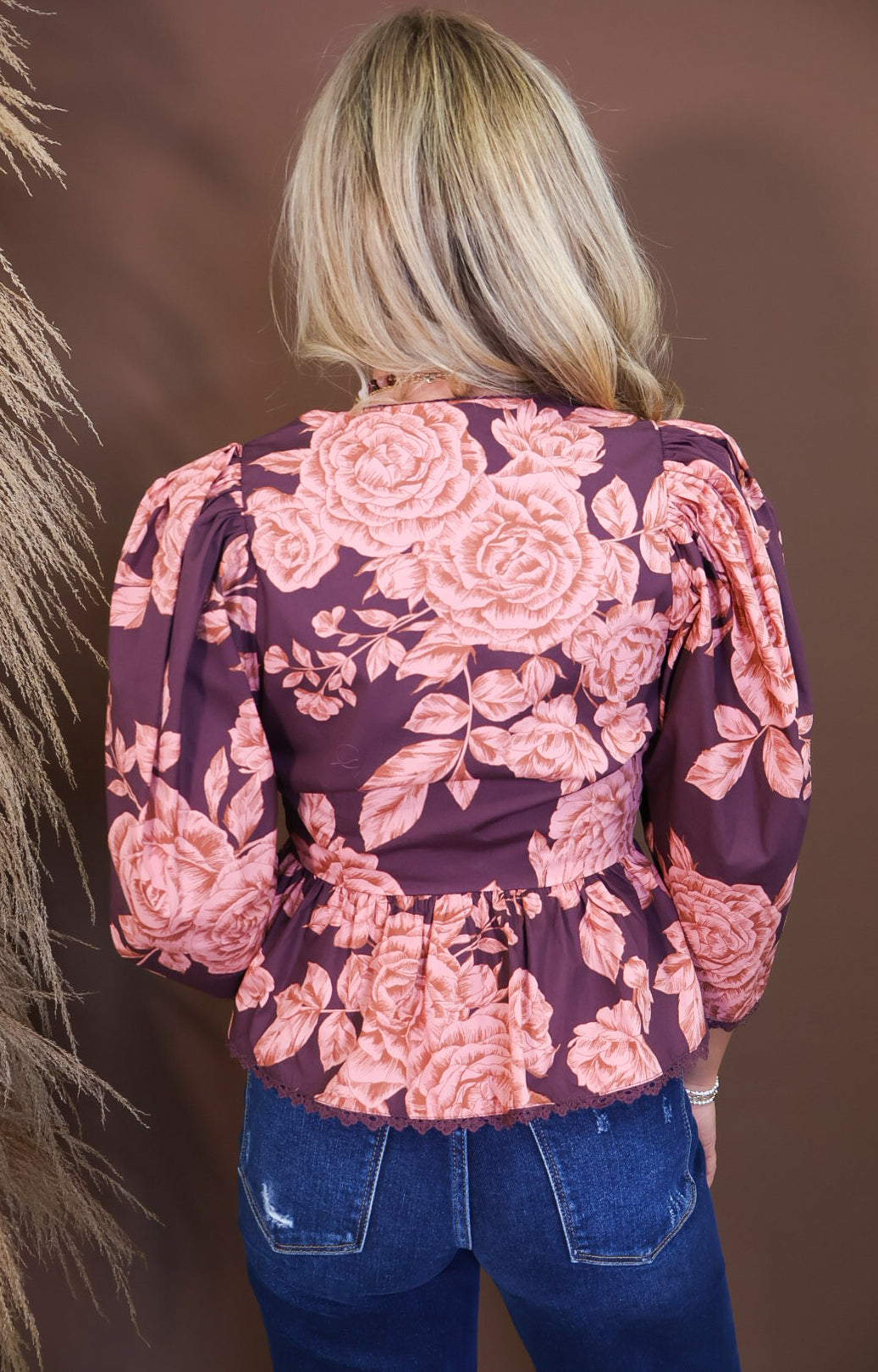 Model wearing the Wine Pink Floral V Neck Top from Moda Boutique
