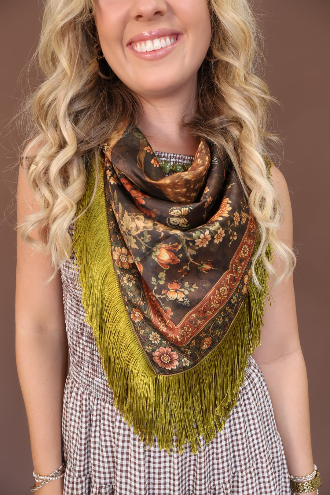 Green Deer Print Fringe Square Scarf — close-up of neck styling.