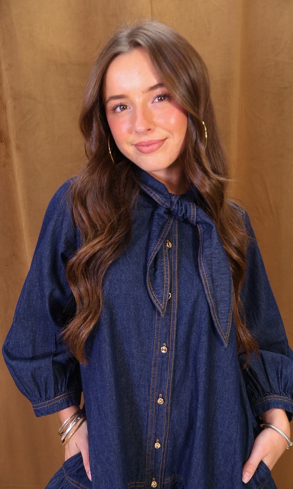 Dark Denim Tie-Neck Babydoll Dress — close-up of puff sleeve and bodice.