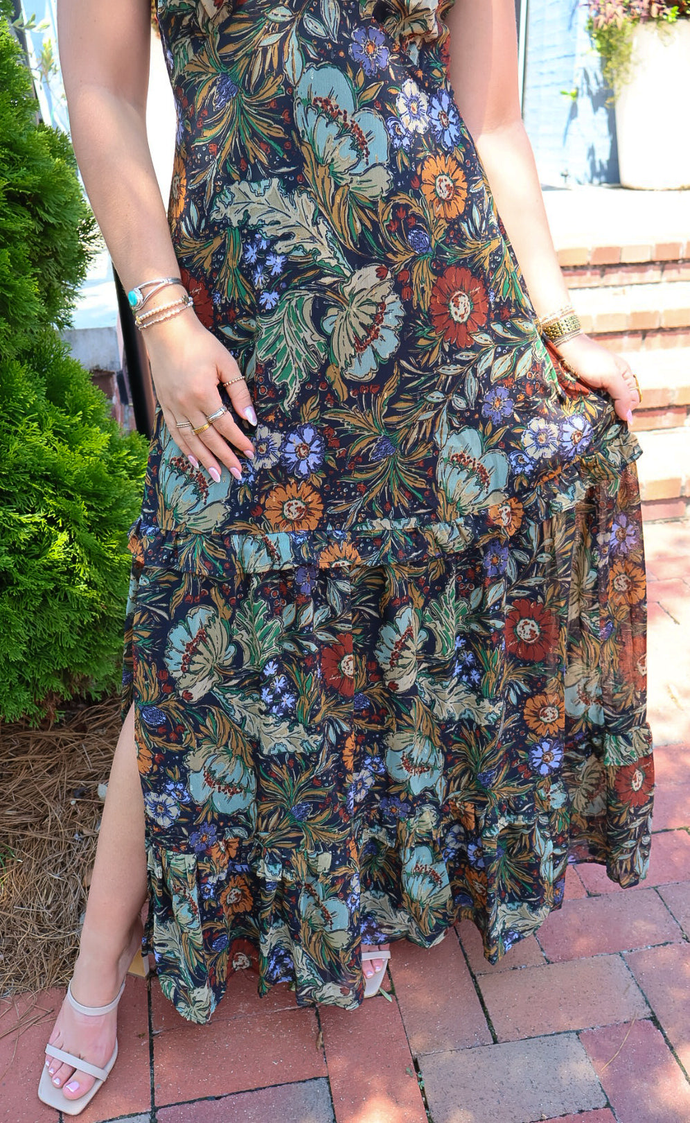 Bohemian floral maxi dress with a V-neck, flutter sleeves, and a tiered ruffle skirt