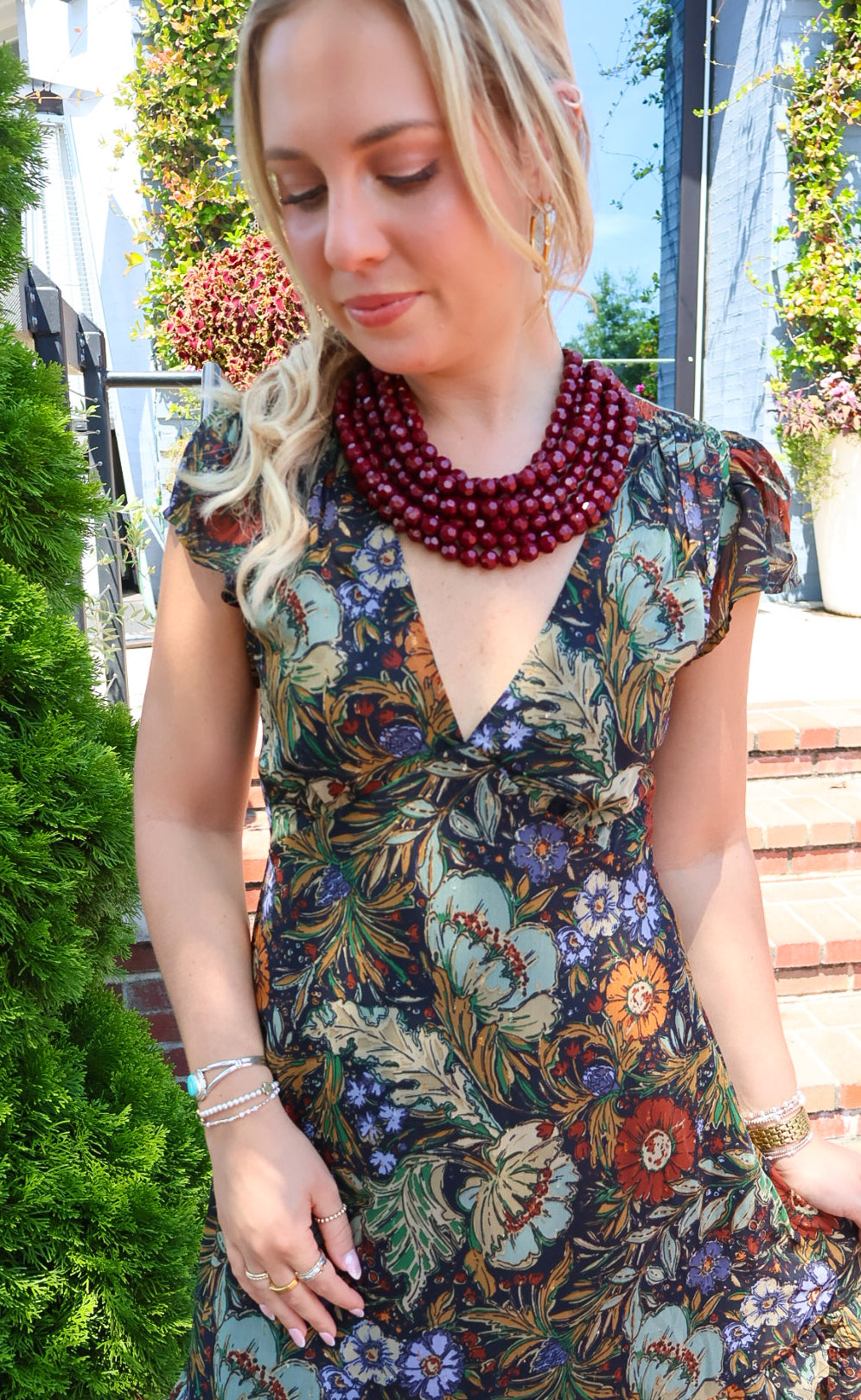 Bohemian floral maxi dress with a V-neck, flutter sleeves, and a tiered ruffle skirt