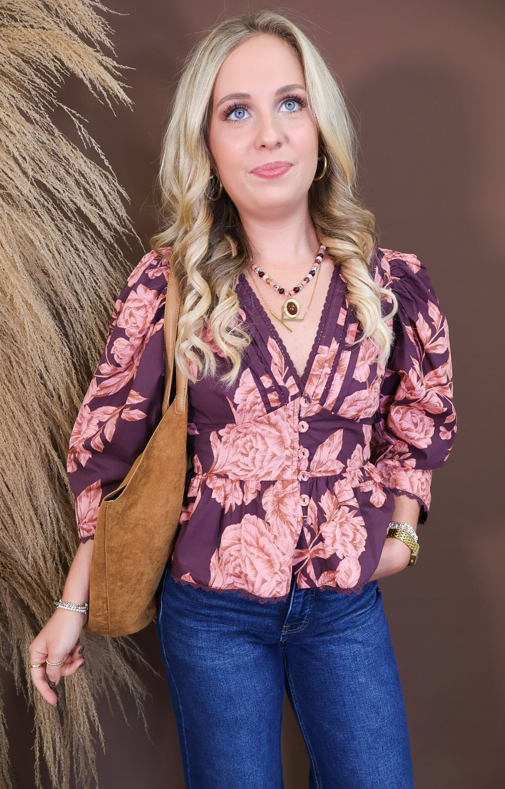 Model wearing the Wine Pink Floral V Neck Top from Moda Boutique