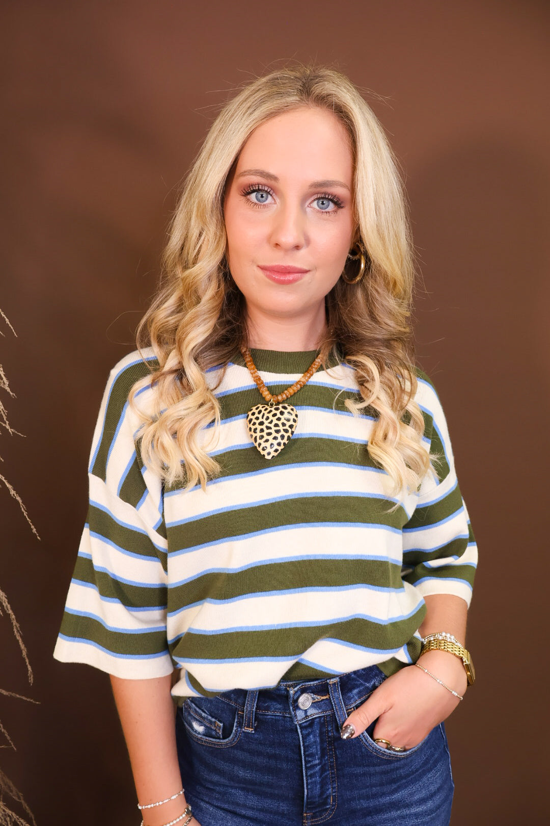 Model wearing the Short Sleeved Lightweight Sweater Top - Green Stripe from Moda Boutique