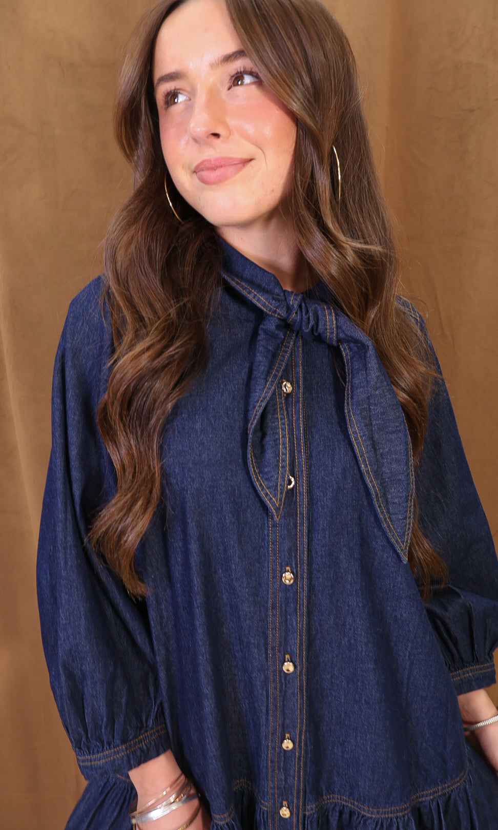 Dark Denim Tie-Neck Babydoll Dress — close-up of tie neckline and buttons.