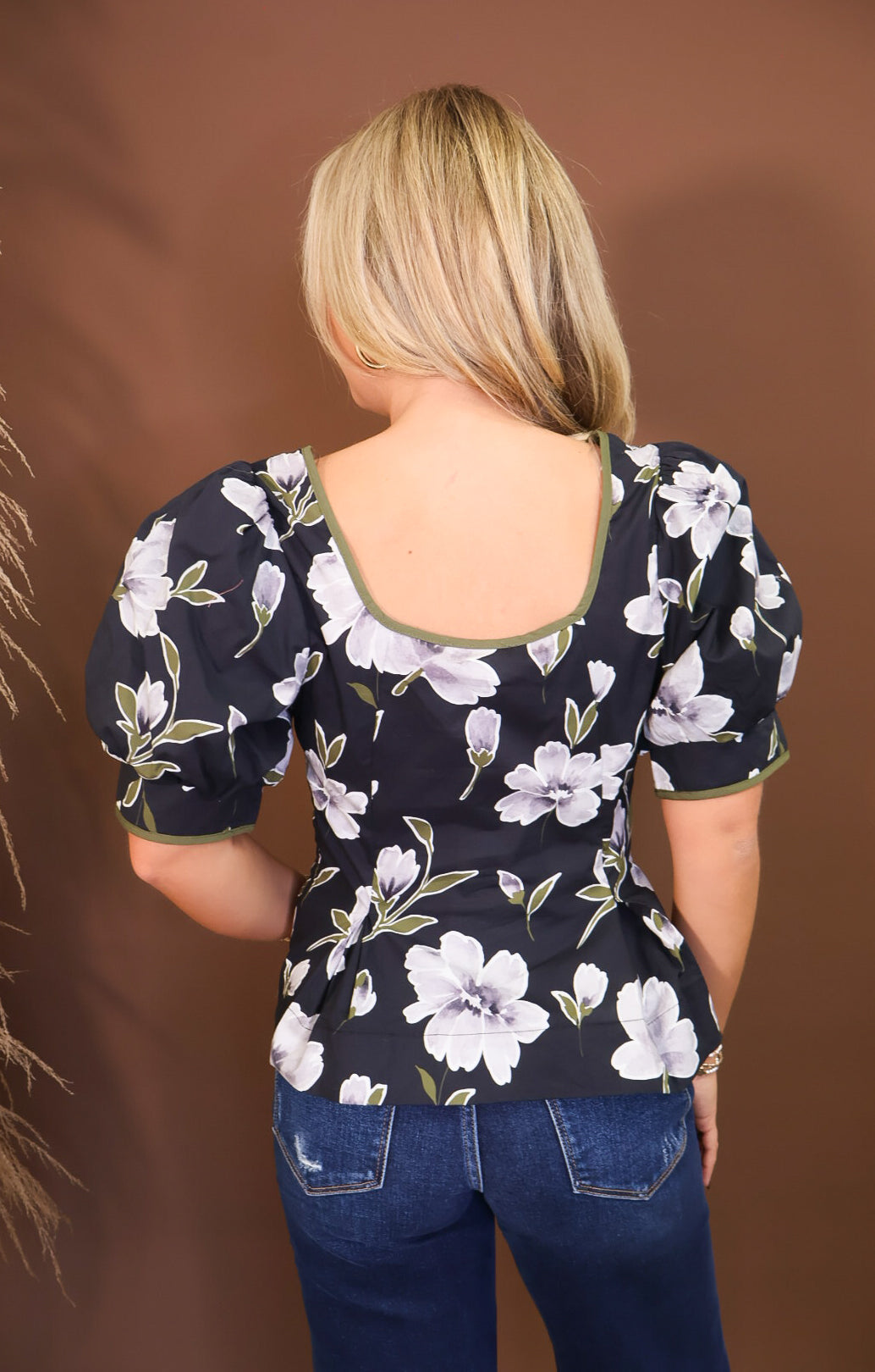 Model wearing the Black Floral Puff Sleeve Fitted Top from Moda Boutique