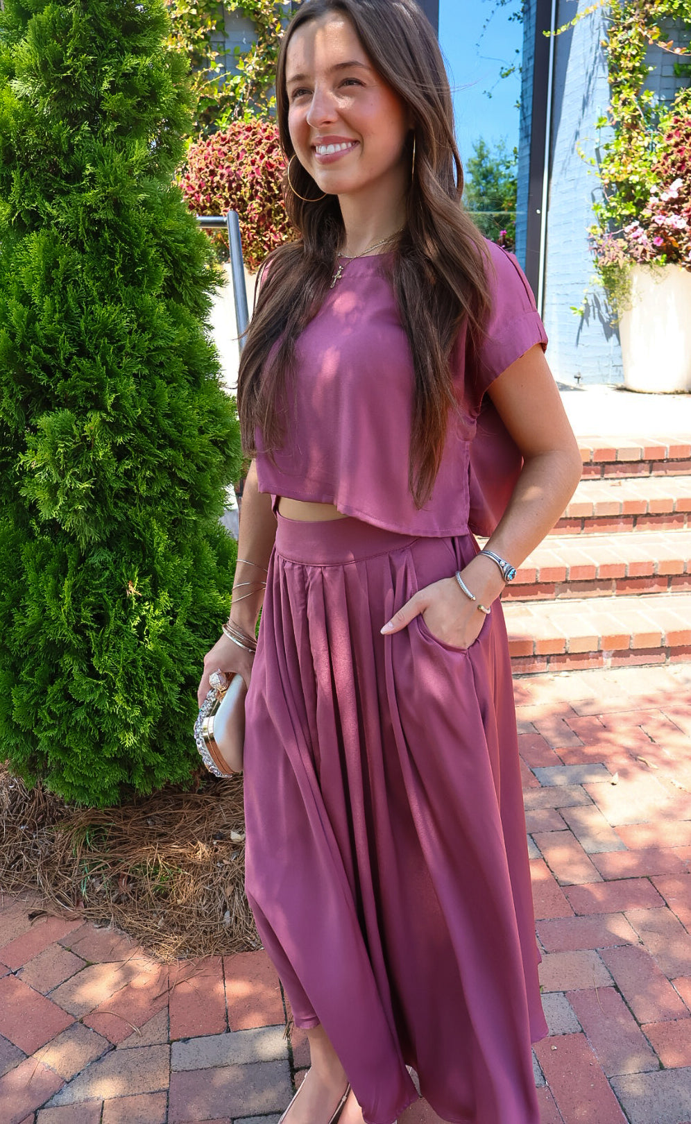 Mauve satin two-piece set with a boxy crop top and pleated midi skirt