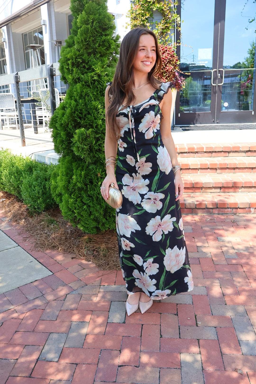 Black floral maxi dress with blush and cream blooms, ruffle straps, and a self-tie bust