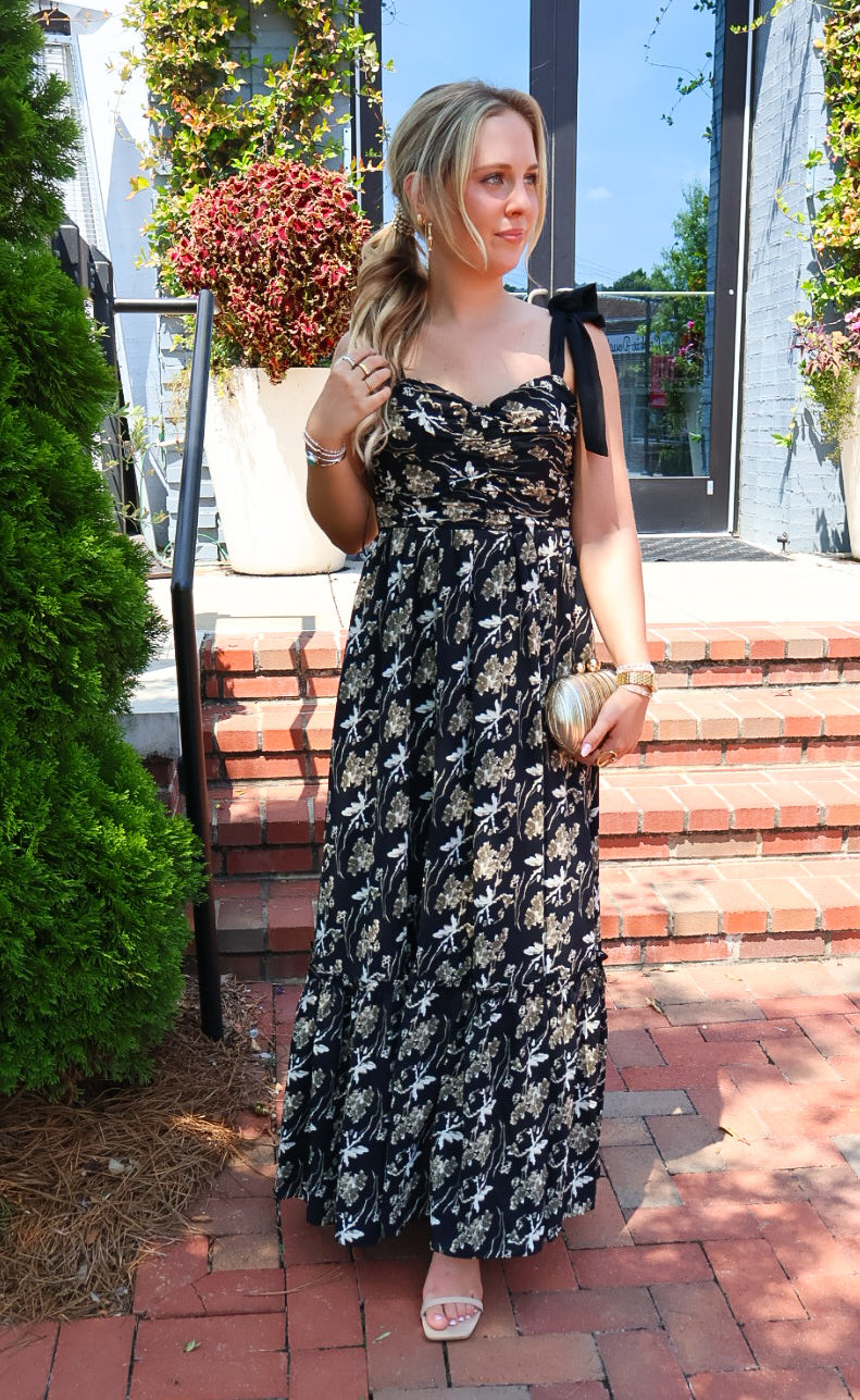 Black maxi dress with gold floral embroidery and ribbon shoulder ties
