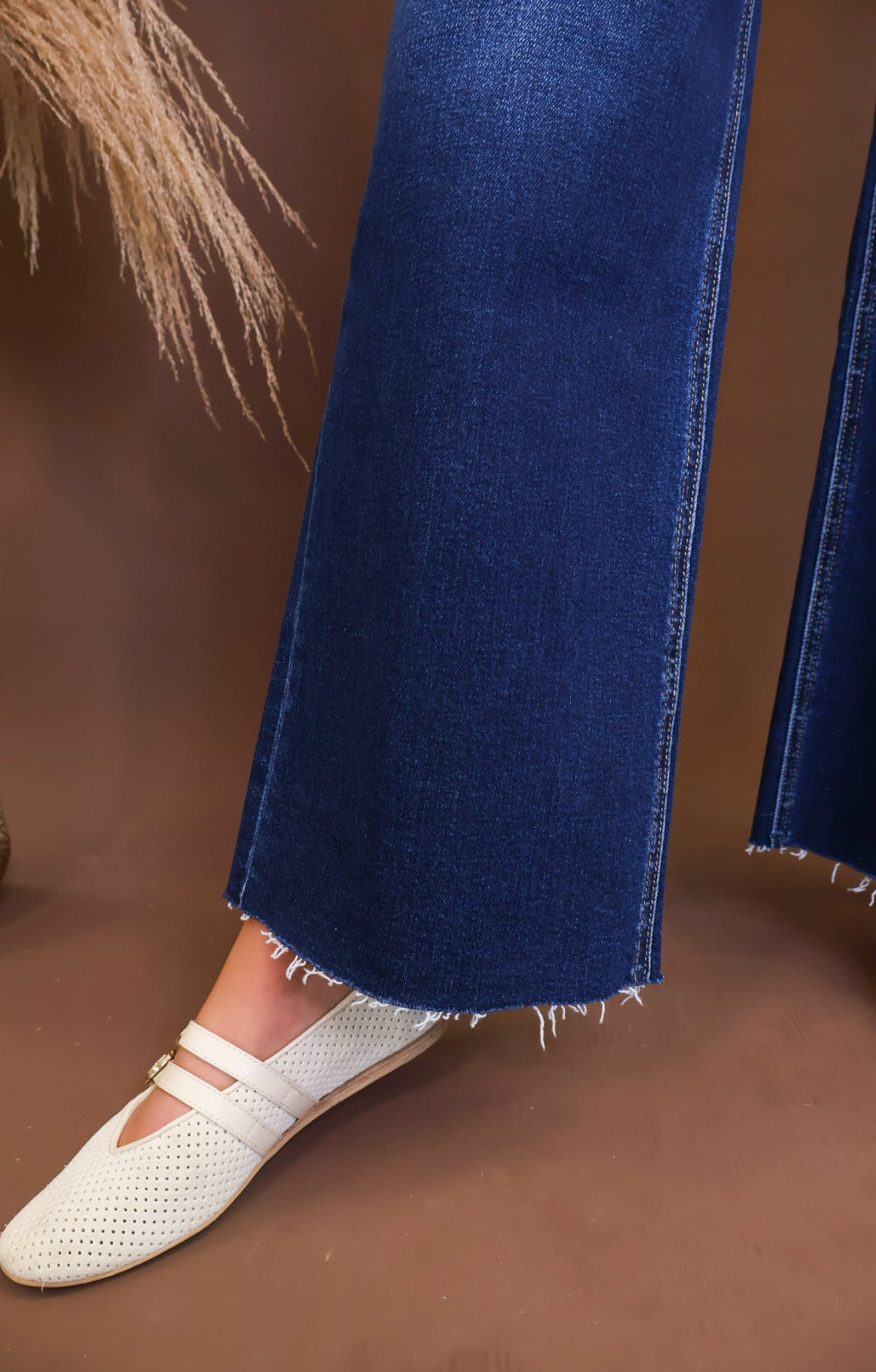 Raw hem detail on Lovervet dark-wash cropped jeans