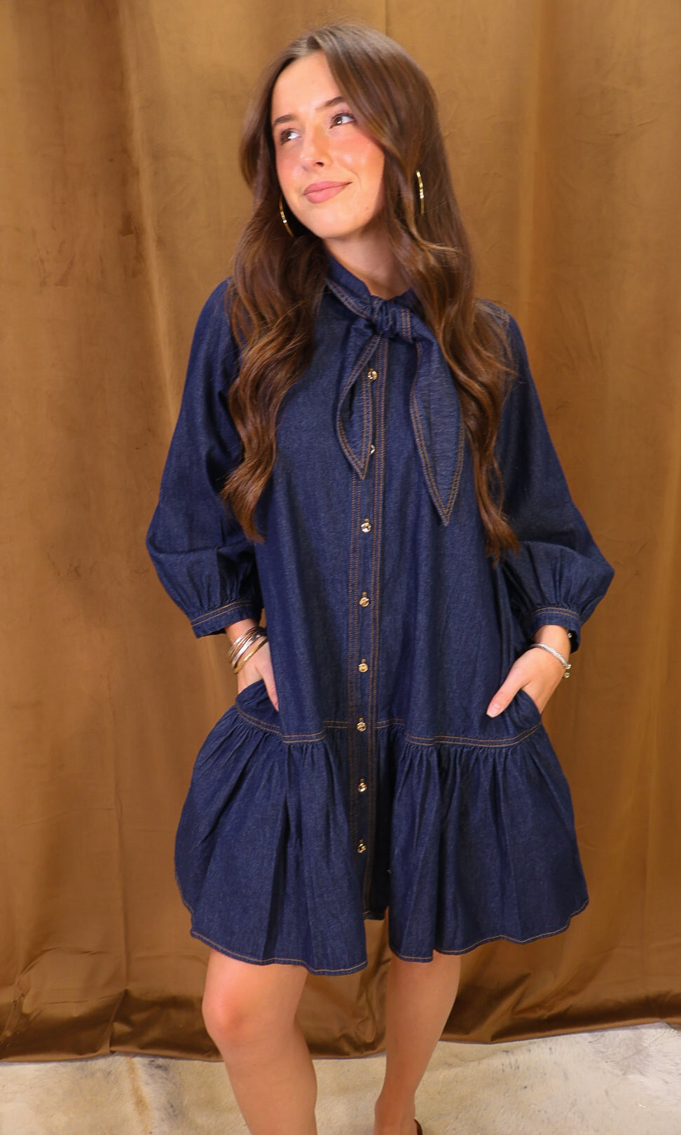 Dark Denim Tie-Neck Babydoll Dress — front view showing pockets.