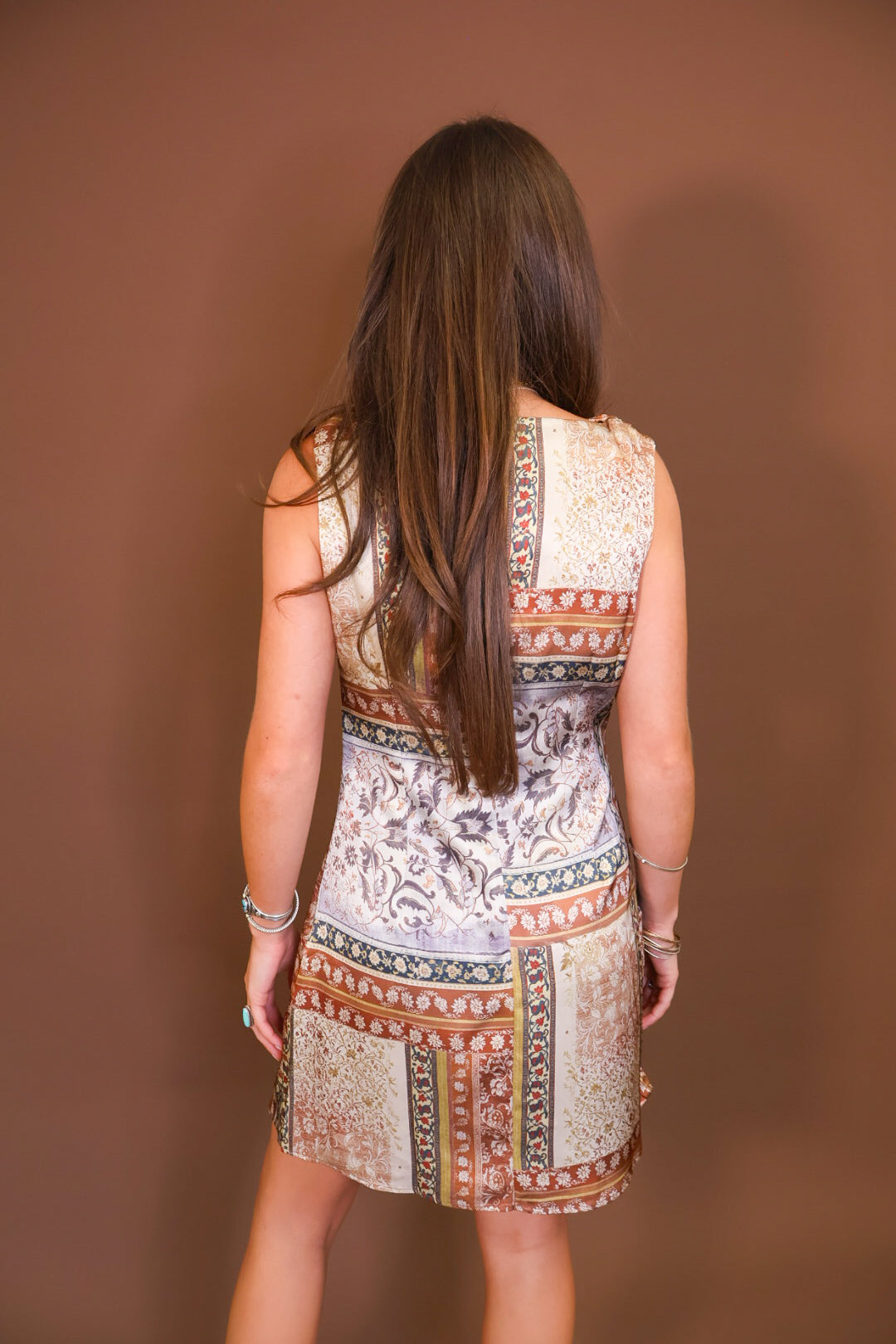 Model wearing the Patchwork Printed Satin Cowl Neck Mini Dress from Moda Boutique