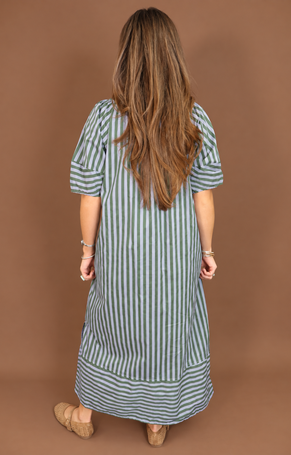 Model wearing the Blue Green Striped Midi Dress from Moda Boutique