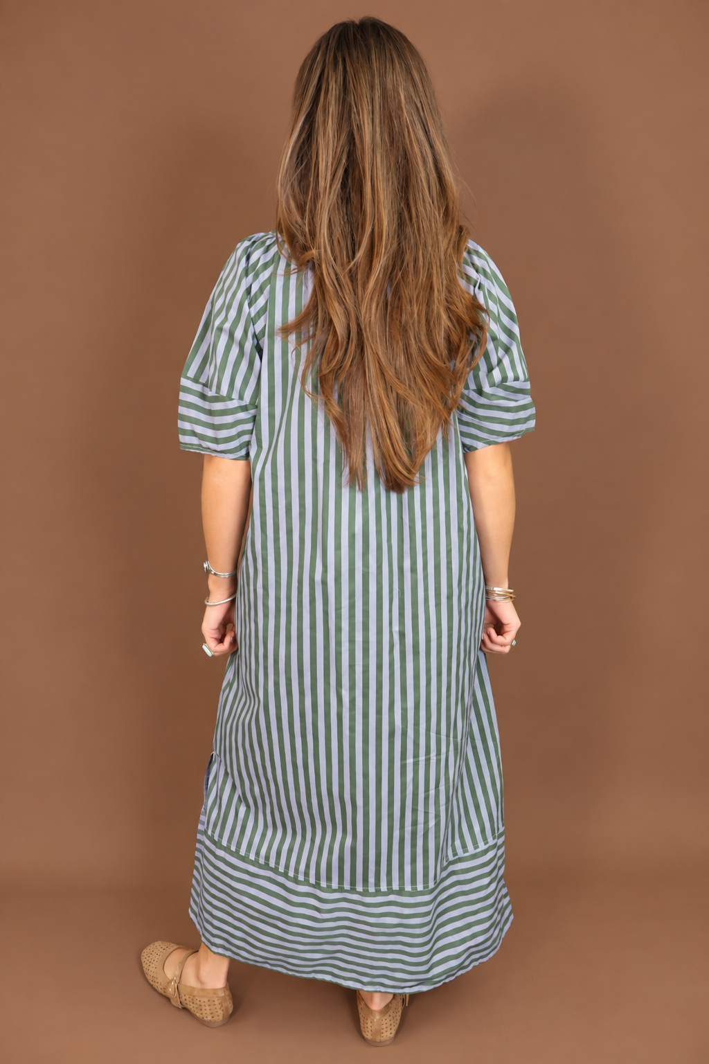 Model wearing the Blue Green Striped Midi Dress from Moda Boutique