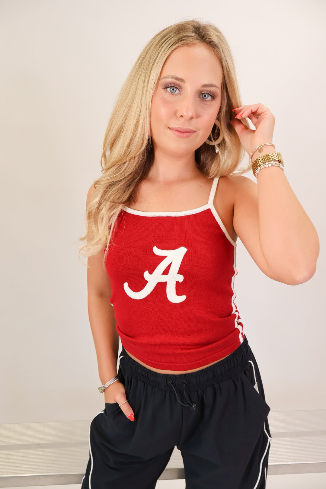 Crimson knit tank top with white script A and adjustable straps on model