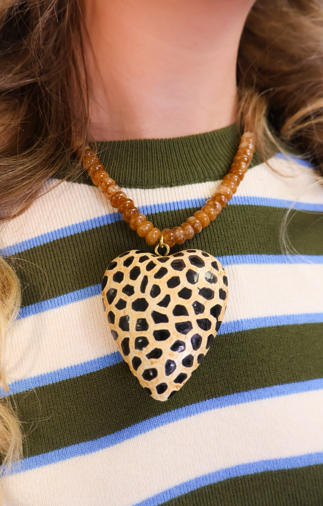 Spotted wooden heart pendant on amber beaded necklace