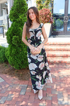 Black floral maxi dress with blush and cream blooms, ruffle straps, and a self-tie bust