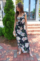 Black floral maxi dress with blush and cream blooms, ruffle straps, and a self-tie bust