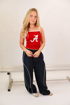 Black track pants with white side piping and drawstring waist — view 5