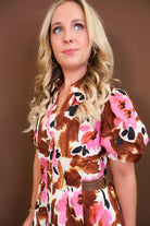Model wearing the Brown & Pink Floral Puff Sleeve Dress from Moda Boutique