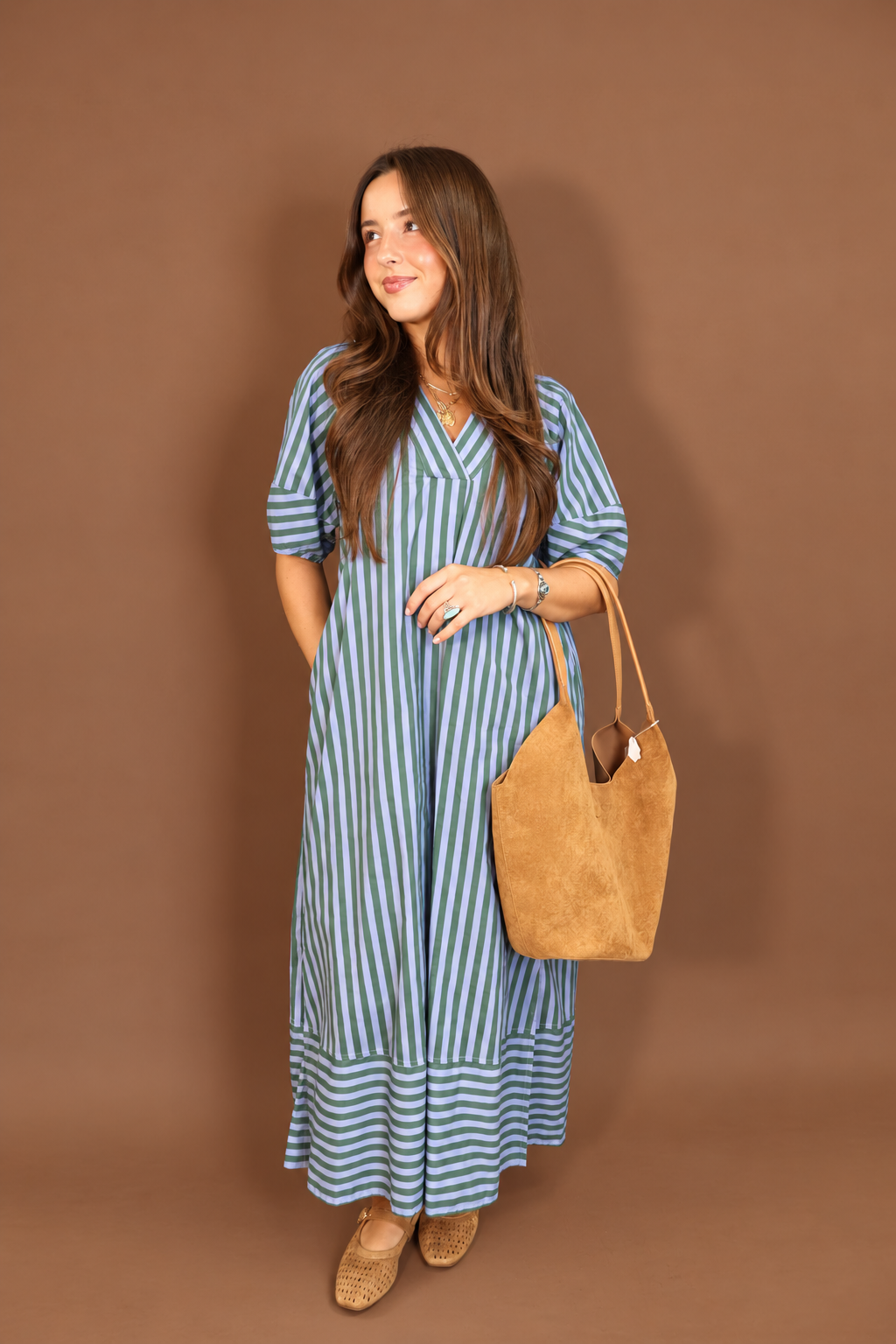 Model wearing the Blue Green Striped Midi Dress from Moda Boutique