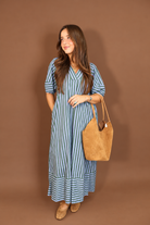 Model wearing the Blue Green Striped Midi Dress from Moda Boutique