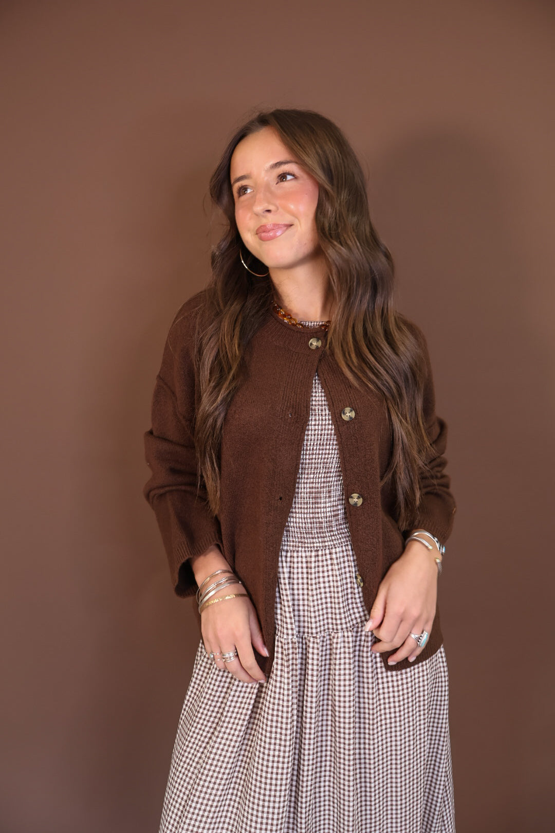 Chocolate Brown Button-Front Cardigan — worn open over a gingham dress.