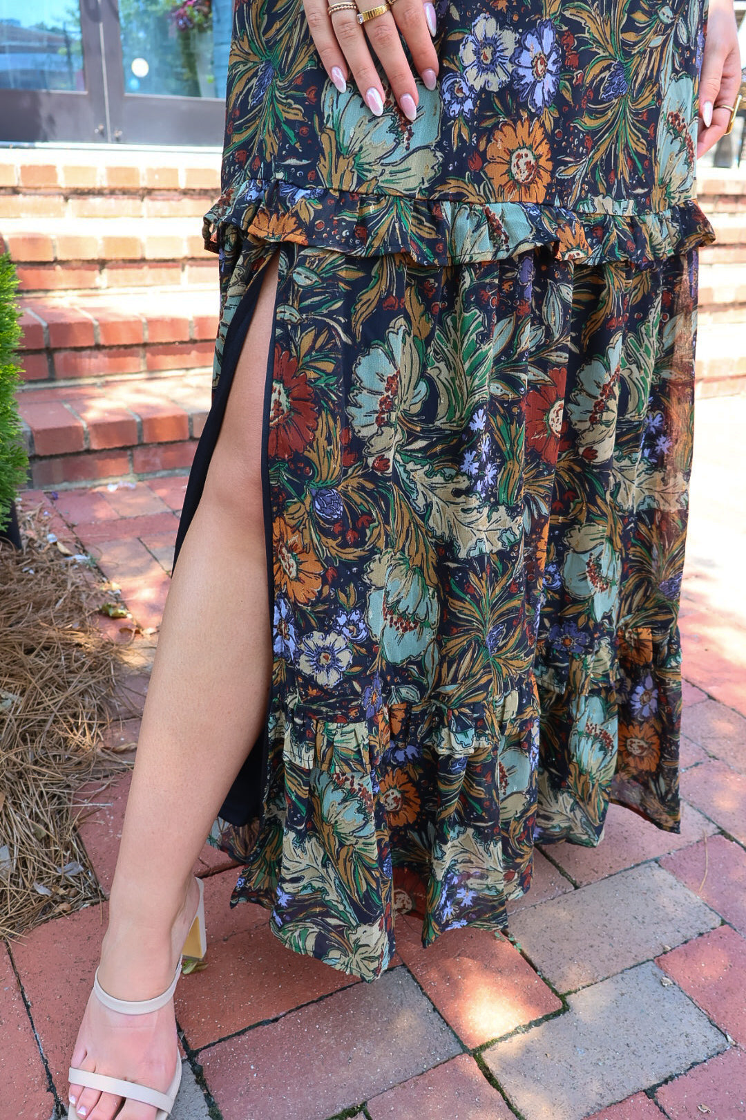 Bohemian floral maxi dress with a V-neck, flutter sleeves, and a tiered ruffle skirt