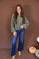 Olive Pom Pom Knit Cardigan — full outfit with blue jeans.