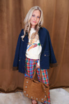Cream cropped mallard graphic sweatshirt — layered with a navy jacket.