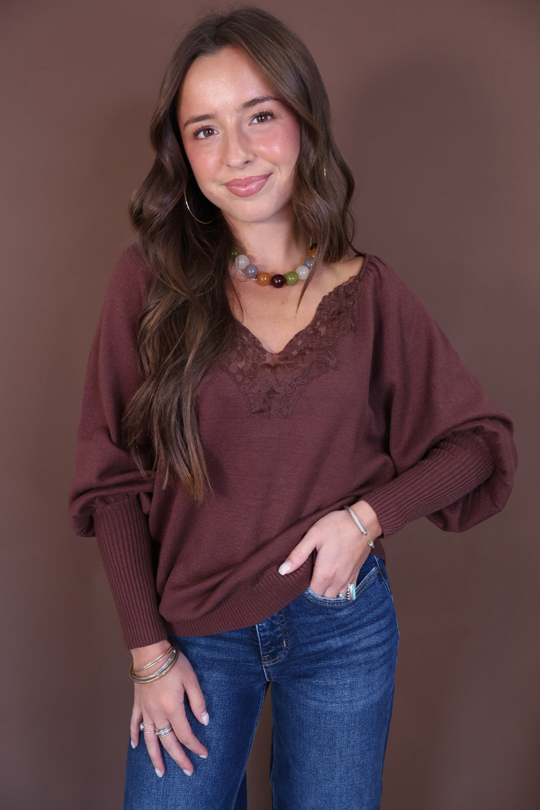 Brown Lace Neckline Sweater — front view with jeans.