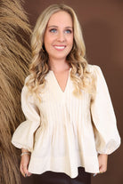 Model wearing the Cream Pintuck Quarter Sleeve Top from Moda Boutique