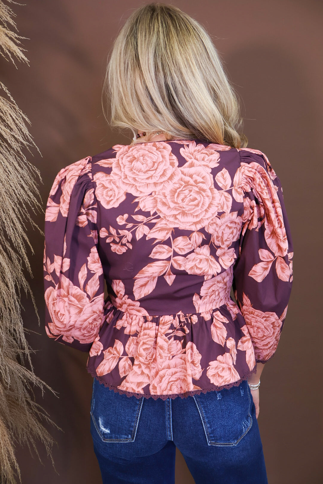 Model wearing the Wine Pink Floral V Neck Top from Moda Boutique