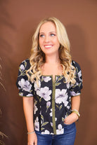 Model wearing the Black Floral Puff Sleeve Fitted Top from Moda Boutique