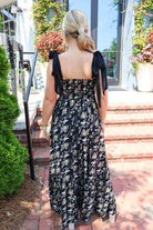 Black maxi dress with gold floral embroidery and ribbon shoulder ties