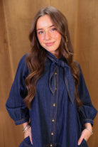 Dark Denim Tie-Neck Babydoll Dress — close-up of puff sleeve and bodice.