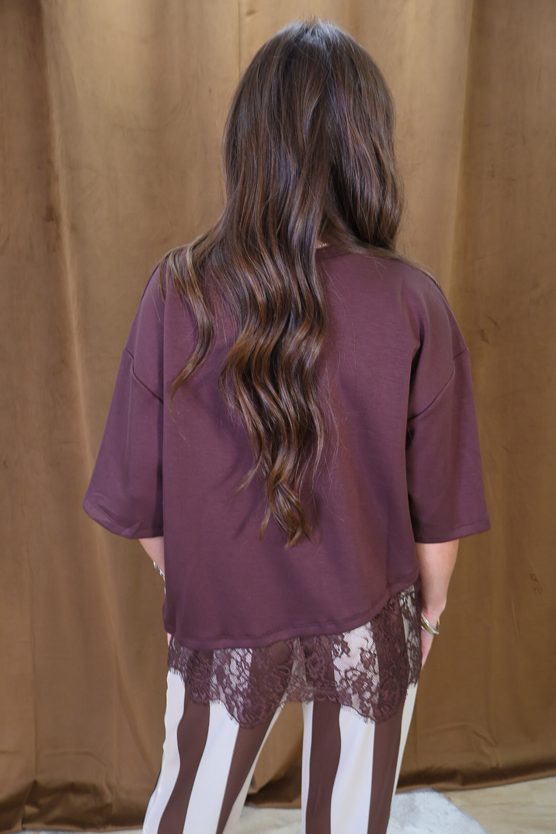 Brown Tee With Asymmetrical Lace Hem — back view.