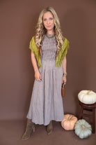 Brown Gingham Smocked Sleeveless Midi Dress — styled with a printed scarf around the shoulders.