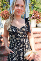 Black maxi dress with gold floral embroidery and ribbon shoulder ties