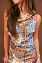 Model wearing the Patchwork Printed Satin Cowl Neck Mini Dress from Moda Boutique