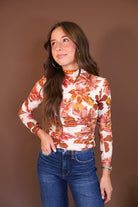 Ivory Floral Fitted Long Sleeve Mesh Top — front view with jeans.