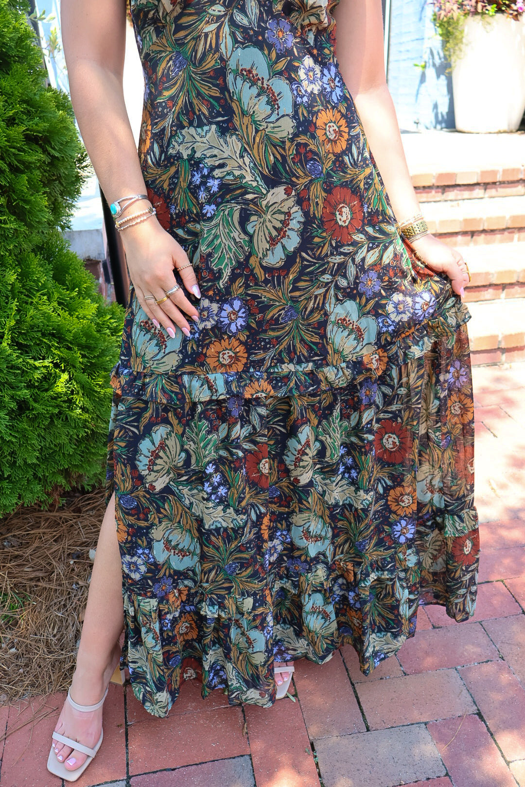 Bohemian floral maxi dress with a V-neck, flutter sleeves, and a tiered ruffle skirt