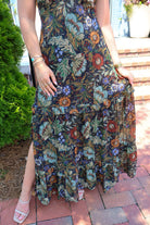 Bohemian floral maxi dress with a V-neck, flutter sleeves, and a tiered ruffle skirt