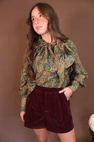 Burgundy Brushed Velvet Trouser Shorts — full outfit with tall boots.